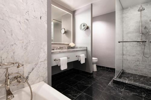 a bathroom with a tub and a sink and a shower at Four Seasons Hotel Atlanta in Atlanta