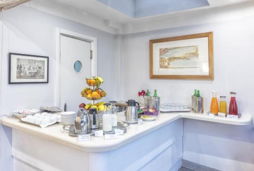 a kitchen with a counter with a bunch of food at Palazzo Turchini in Naples