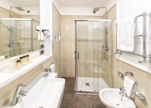 a bathroom with a shower and a sink and a toilet at Palazzo Turchini in Naples