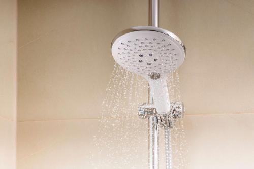 a shower head with a hose attached to it at NH Collection Santiago Casacostanera in Santiago
