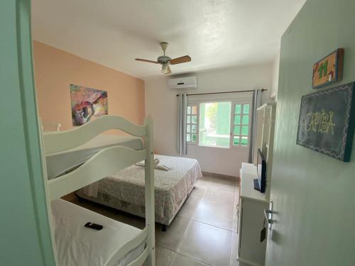 a bedroom with a bunk bed and a ceiling fan at Pousada Liras da Poesia in Porto De Galinhas