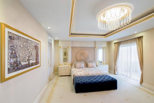 a bedroom with a bed and a large window at Qafqaz Riverside Hotel in Gabala