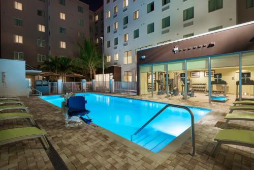 a swimming pool at night in a hotel at Staybridge Suites - Miami International Airport, an IHG Hotel in Miami