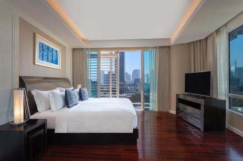 Dusit Suites Hotel Ratchadamri, Bangkok tesisinde bir odada yatak veya yataklar