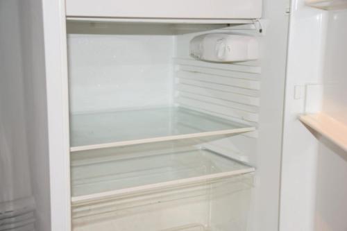 a white refrigerator with its door open at Hôtel Résidence Champerret in Levallois-Perret