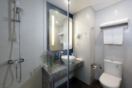 a bathroom with a toilet and a sink and a shower at Holiday Inn Express - Xiamen City Center, an IHG Hotel in Xiamen