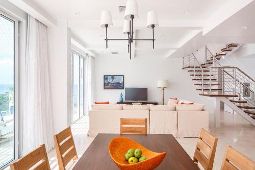 a living room with a table and a couch at Windjammer Landing Resort and Residences in Gros Islet