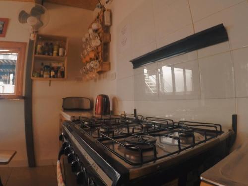 a kitchen with a stove top oven in a kitchen at Rey Lagarto Hostel in San Pedro de Atacama