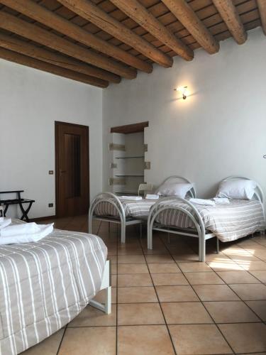 a bedroom with two beds and a wooden ceiling at Ai Leoni in Verona