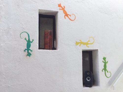 a white wall with lizard stickers on it at Rey Lagarto Hostel in San Pedro de Atacama
