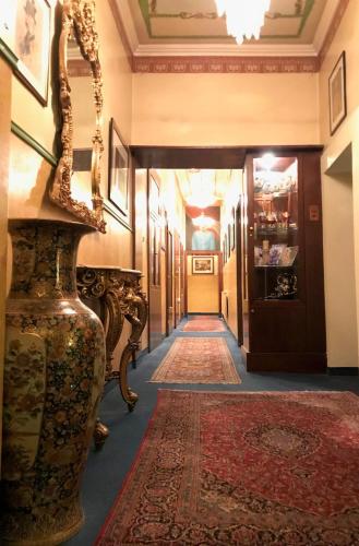 a hallway in a building with a rug at Cityhotel Ratheiser in Klagenfurt