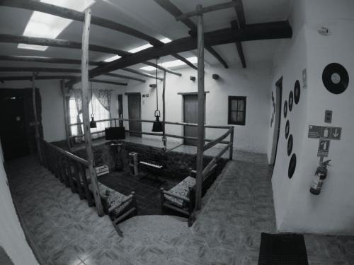 a room with a bed in the middle of a building at Rey Lagarto Hostel in San Pedro de Atacama