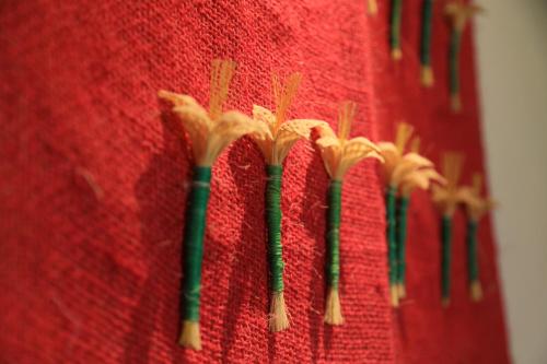 a group of four bamboo sticks on a red wall at El Molino Hotel Boutique in Río Verde