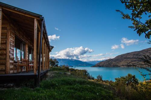 a cabin with a view of a lake at Mallin Colorado Ecolodge in Aldana