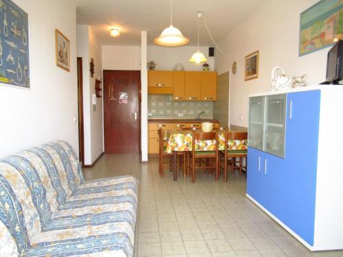 a living room with a couch and a kitchen at Apartment in Porto Santa Margherita 25675 in Porto Santa Margherita di Caorle
