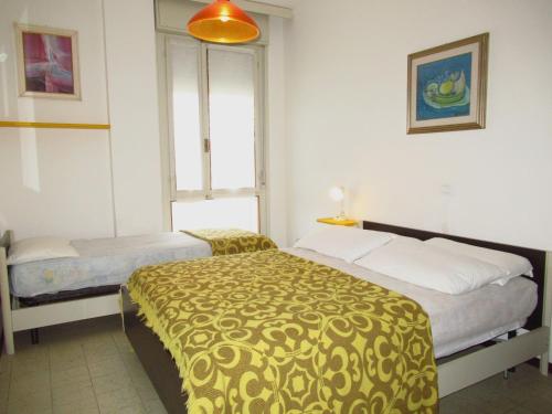 a hotel room with two beds and a window at Apartment in Porto Santa Margherita 25675 in Porto Santa Margherita di Caorle