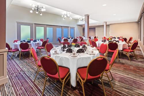 a conference room with tables and chairs and tablesktop at Holiday Inn Tyler - Conference Center by IHG in Tyler