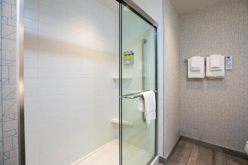 a bathroom with a glass shower stall with towels at Holiday Inn Express - Lethbridge Southeast by IHG in Lethbridge