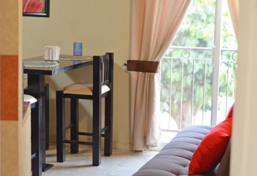 a table and chair in a room with a window at Hotel Gesa in Villa Corona