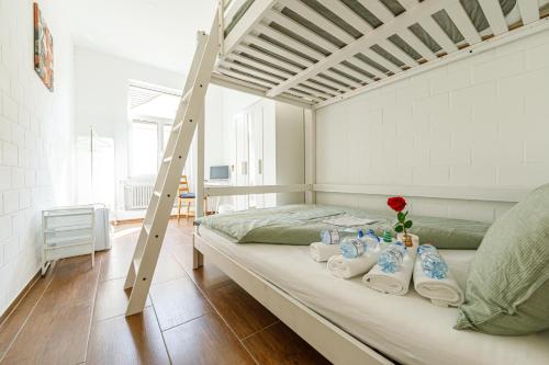 a bedroom with a bunk bed with a ladder at Simple Rooms - Yellow Inn in St. Gallen