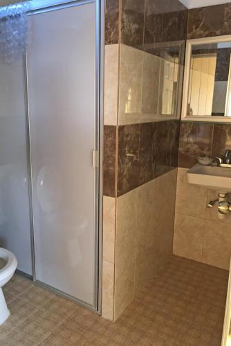a bathroom with a shower and a sink and a toilet at Hotel Gesa in Villa Corona