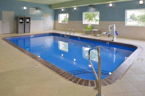 a large swimming pool in a hotel room at Holiday Inn Express & Suites - Omaha - 120th and Maple, an IHG Hotel in Omaha