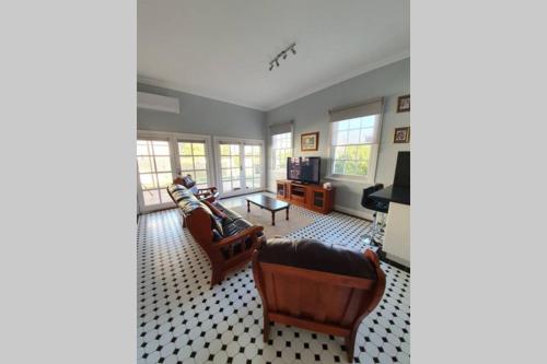 a living room with two couches and a tv at Bellview Holiday House in Wentworth