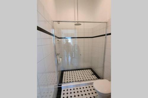 a bathroom with a shower with a toilet at Bellview Holiday House in Wentworth