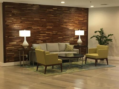 a living room with a couch and two chairs and a table at Holiday Inn Hotel & Suites Daytona Beach On The Ocean by IHG in Daytona Beach