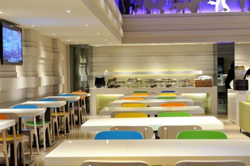 a dining room with white tables and chairs at Green World Hotel - Zhonghua in Taipei