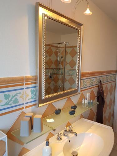 a bathroom with a sink and a mirror at Ferienappartement am Nadenberg in Lindenberg im Allgäu