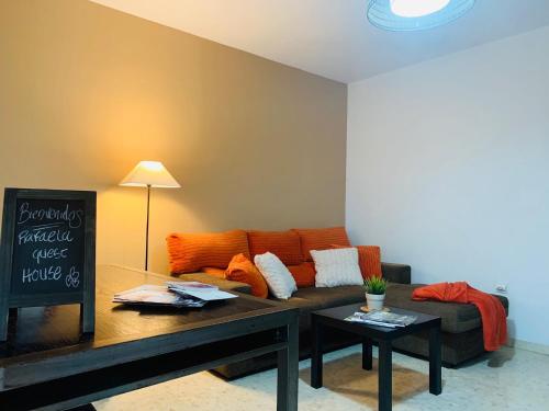a living room with a couch, coffee table and a lamp at Rafaela Guest House in Málaga