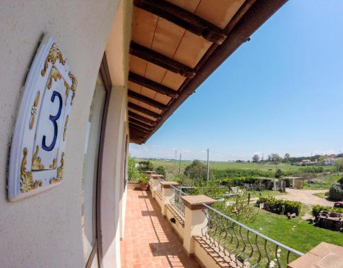 a balcony of a building with a sign on it at Villa Enli in Capalbio