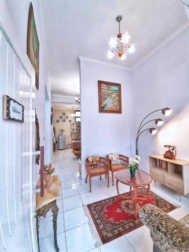 a living room with a table and chairs at Rumah Sorai in Batu