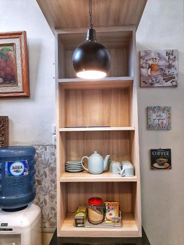 a cupboard with a light on top of a toilet at Rumah Sorai in Batu