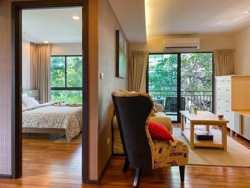 a bedroom with a bed and a desk and a chair at Title Rawai Phase III by Beringela in Rawai Beach