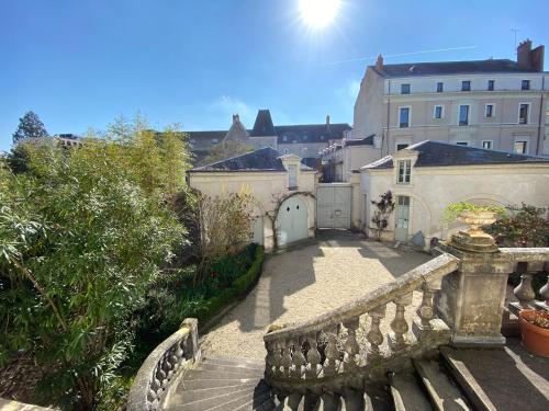 a view of a balcony with a bench and buildings at Lysbed - Chevreul in Angers