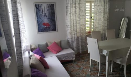 a living room with a couch and a table at Barko apartment and rooms in Hvar