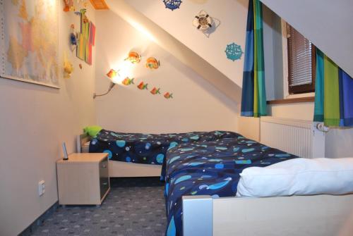 a bedroom with two beds in a room at Holiday House Arnultovice in Rudník