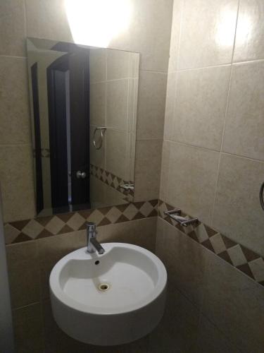 a bathroom with a sink and a mirror at Hotel Villa Del Sol Expo in Guadalajara