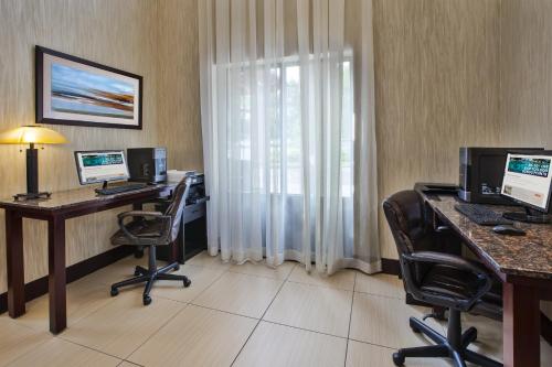 an office with two computer desks and two monitors at Holiday Inn Express & Suites Geneva Finger Lakes by IHG in Geneva