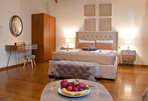 a bedroom with a bed with a plate of fruit on a table at Casa Del Mar in Chania Town