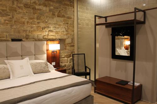 a bedroom with a bed and a table and a mirror at Donati Luxury Tower Suites in Florence