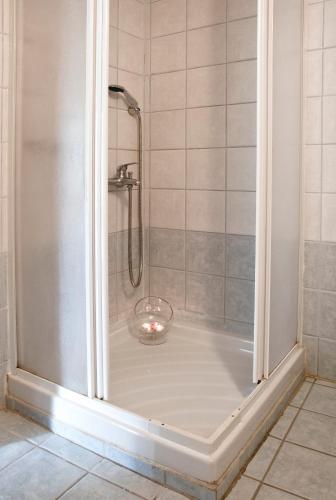 a shower with a glass bowl in a shower stall at Casa Del Mar in Chania