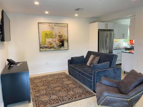 a living room with a couch and a chair at Captiva Beach Resort (open private beach access) in Sarasota