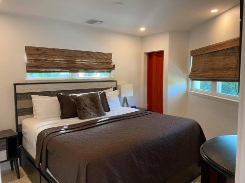 a bedroom with a large bed with a wooden headboard at Captiva Beach Resort (open private beach access) in Sarasota