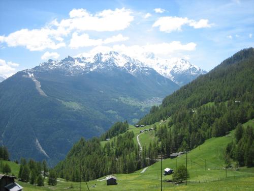 a view of a mountain range with snow capped mountains at Chalet Sven & Marc Grächen, Niedergrächen Vallis in Sankt Niklaus