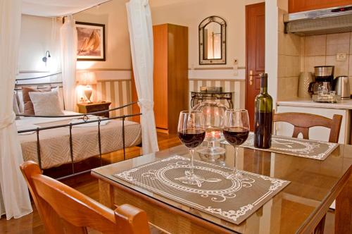 two glasses of wine on a table in a room at Casa Del Mar in Chania Town