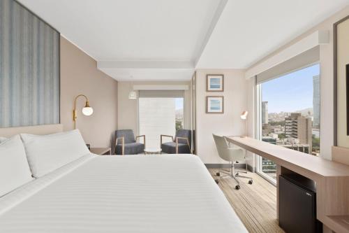 a hotel room with a large bed and a desk at Holiday Inn Express - Lima San Isidro by IHG in Lima