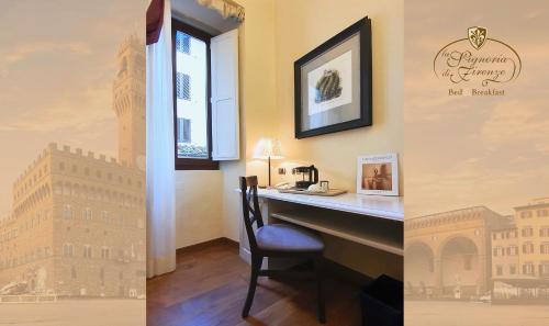 a desk with a chair and a picture of thefamous building at B&B La Signoria Di Firenze in Florence
